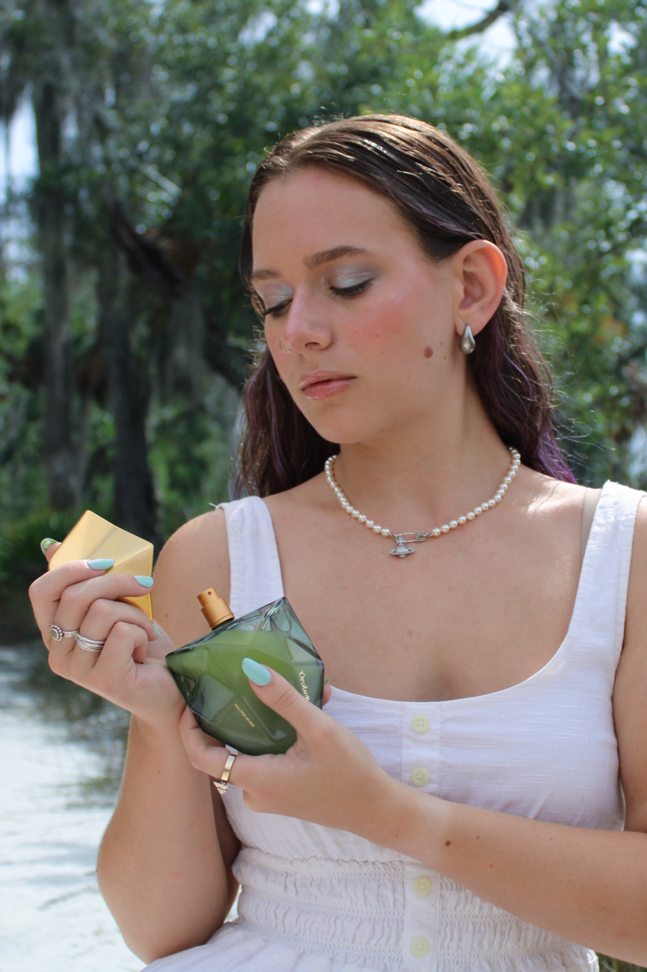 Salted Muse — studying the bottle, Spanish moss behind