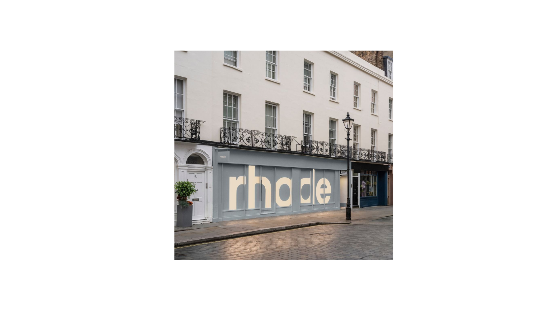 London storefront takeover — rhode hoarding wrapping a Mayfair-style townhouse facade